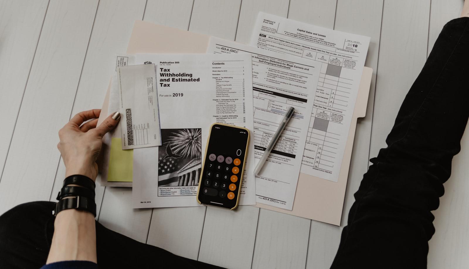 Tax documents and a calculator on a desk